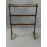 A 19th century mahogany towel rail on turned supports resting on platform feet. H.91 L.66 W.30cm