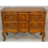 A French provincial chestnut two drawer commode on carved cabriole supports. H.87 W.117 D.48cm