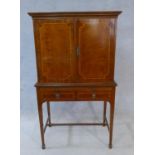 A Georgian style mahogany and satinwood strung cocktail cabinet with mirrored and shelved interior