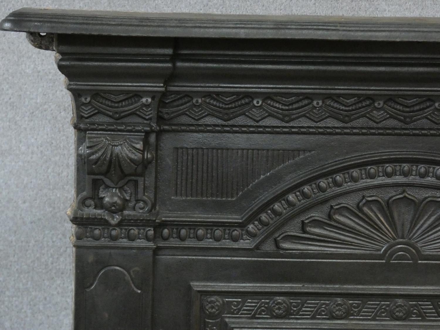 An ornately cast 19th century iron fire surround, mantel shelf and insert with grate on marble - Image 5 of 12