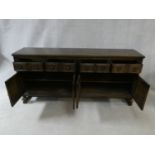 A mid century oak Jacobean style sideboard with linenfold panels on squat baluster supports. H.88