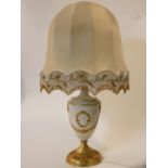An Empire style gilt glazed ceramic table lamp with central cartouche and husk swag decoration. H.