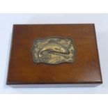 A wooden fishing tackle box with embossed plaque with trout along with an optician's Ultra Lense and