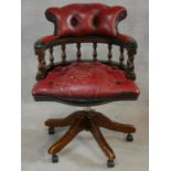 A 19th century style mahogany framed captain's revolving desk chair in buttoned leather