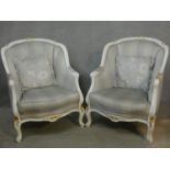 A pair of Louis XV style tub armchairs in damask upholstery and gilt and white painted frames on