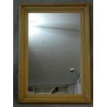 A rectangular wall mirror in moulded pine frame. H.131 W.95cm