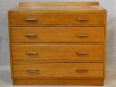 A mid century teak chest of four long drawers on plinth base. H.78 W.91 D.48cm