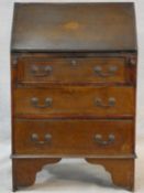 An Edwardian mahogany bureau with satinwood stringing and shell inlay to the frieze. H.95 W.61 D.