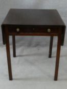 A Georgian mahogany drop flap Pembroke table fitted with frieze drawer on square chamfered supports.