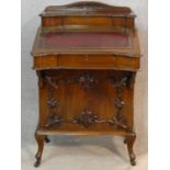 A late 19th century mahogany Davenport with tooled leather writing slope revealing fitted interior