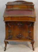 A late 19th century mahogany Davenport with tooled leather writing slope revealing fitted interior