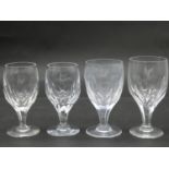 A antique circular etched floral and foliate design crystal decanter with four wine glasses. The