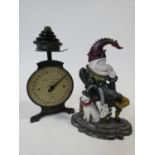A Mr Punch cast iron doorstop along with vintage kitchen scales and a set of weights. H.30cm