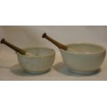 A large 19th century apothecary's ceramic mortar and pestle and another similar, stamped Made in