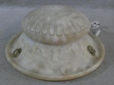 A carved alabaster ceiling light pendant shade of waisted ribbed form. H.19 D.46cm