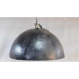 A very large contemporary domed black fibreglass ceiling light with textured and gilded interior.