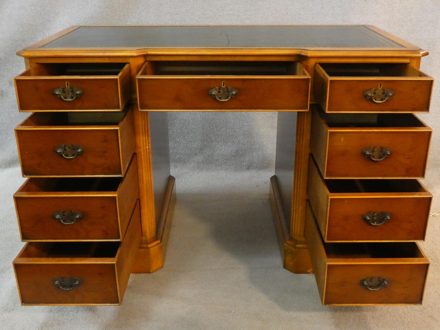 A Georgian style yew pedestal desk with inset tooled leather top above an arrangement of nine - Image 2 of 6