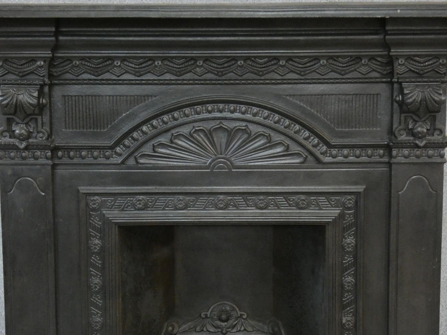 An ornately cast 19th century iron fire surround, mantel shelf and insert with grate on marble - Image 4 of 12