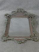 A Venetian style pier mirror set within a blush glazed frame with all over applied floral