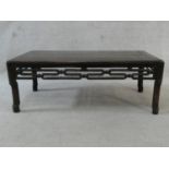 A Chinese hardwood low table with carved and pierced frieze on shaped supports. H.27 L.72 W.38cm