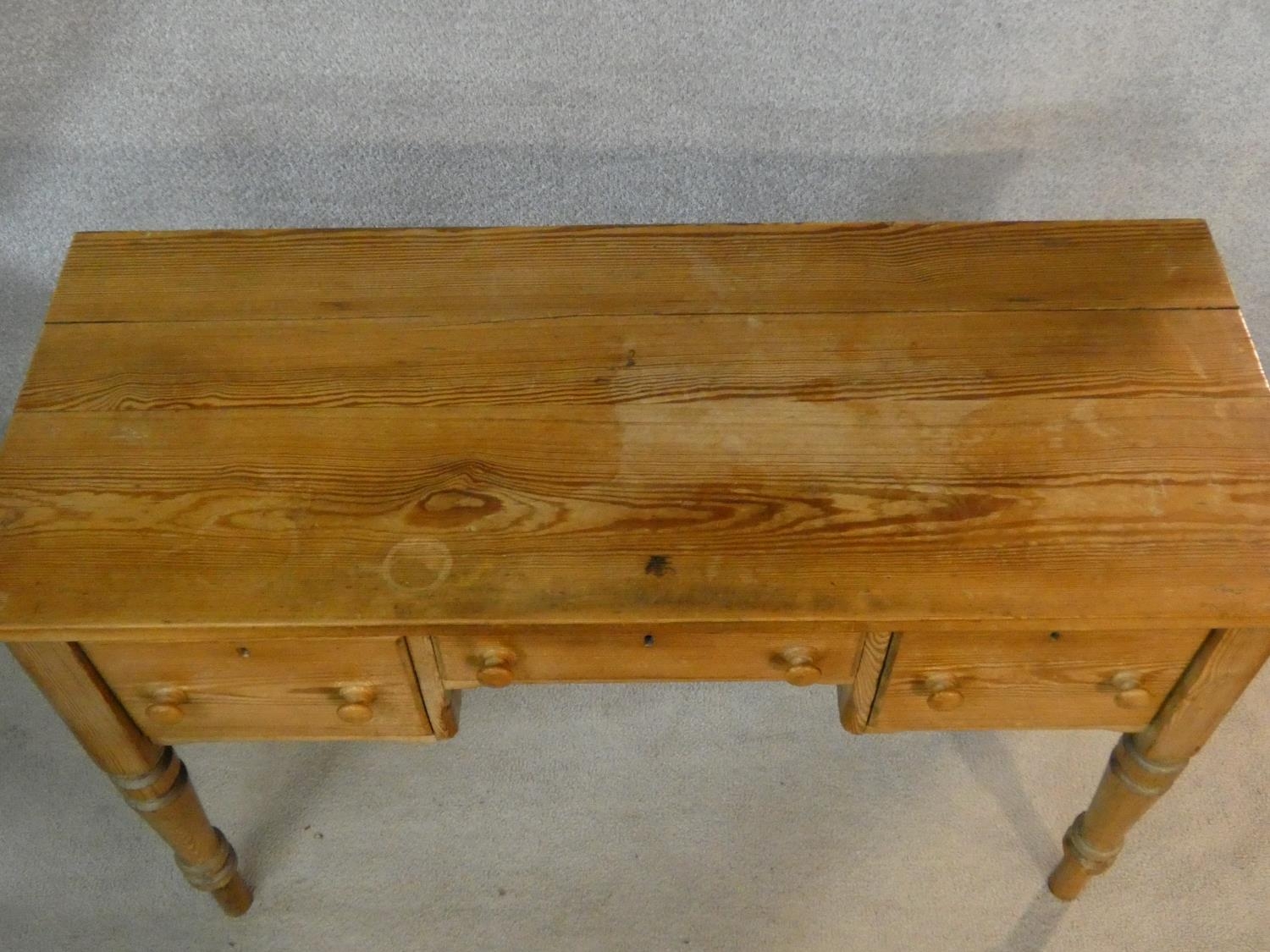 A 19th century pitch pine kneehole writing table with three frieze drawers on turned tapering - Image 3 of 5