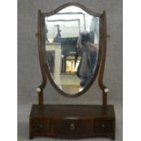 A 19th century mahogany swing dressing mirror on serpentine base fitted with three drawers. H.58 L.