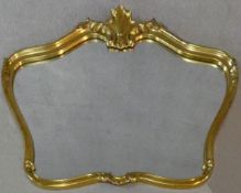 A contemporary shaped gilt frame wall mirror with Rococo shell cresting. H.75 W.102cm