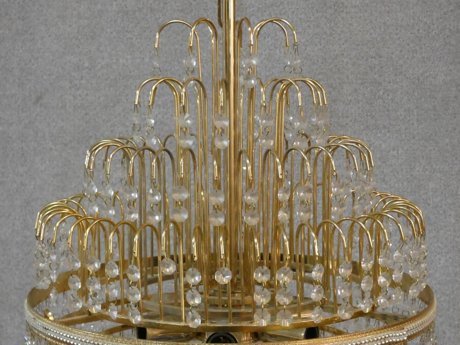 A brass framed four tier wedding cake style chandelier with crystal drops. H.50 D.43cm - Image 2 of 4