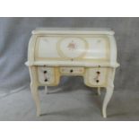 A Louis XV style painted cylinder bureau with roll top enclosing fitted interior and pull out