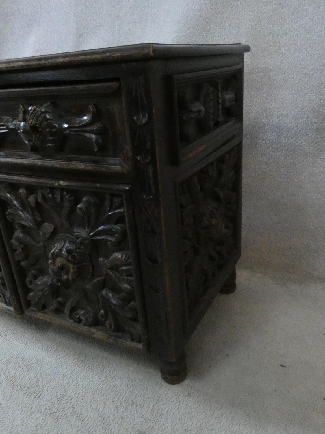 An antique oak side cabinet with carved drawers and doors on circular squat supports. H.73 W.93 D. - Image 7 of 8