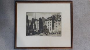 A framed and glazed signed etching by British artist Stanley Anderson RA (1884 - 1966), men at