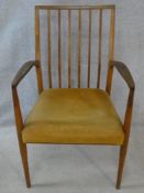 A mid century teak open armchair on shaped tapering supports. H.90cm