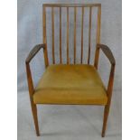 A mid century teak open armchair on shaped tapering supports. H.90cm