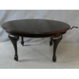 A C.1900 mahogany extending dining table with wind out mechanism and extra leaf on carved cabriole