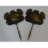 A pair of Victorian hand held face screens with gilt and floral painted decoration with exotic