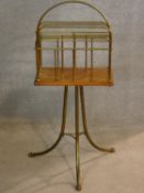 A 19th century walnut and brass Canterbury on swept tripod supports with maker's impressed mark to