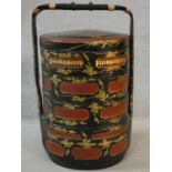 A vintage Chinese four tiered lacquered and gilded marriage basket. Decorated with figures and