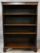 A Georgian style flame mahogany and crossbanded dwarf open bookcase on shaped bracket feet. H.122