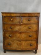 A 19th century mahogany bowfronted chest of drawers with fluted pilasters on turned supports. H.