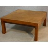 A 1960's vintage teak coffee table on block supports. H.31 L.66 W.66cm