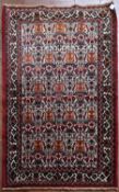 A Persian Hamadan rug with all over herati design on fawn ground within floral borders. L.100xW.