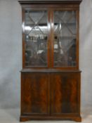 A C.1900 Georgian style library bookcase with astragal glazed doors enclosing bookshelves above