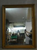 A 19th century wall mirror, the bevelled plate in gadrooned and carved pitch pine frame. H.140 W.