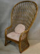 A vintage bamboo peacock style conservatory armchair of waisted outline with latticework back and