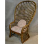 A vintage bamboo peacock style conservatory armchair of waisted outline with latticework back and