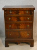 A Georgian style mahogany bachelor's chest with foldover top resting on slides above four drawers on