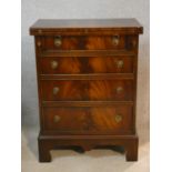 A Georgian style mahogany bachelor's chest with foldover top resting on slides above four drawers on