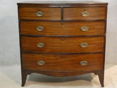 A Regency mahogany bowfronted chest of drawers with original brass plate handles and locks on