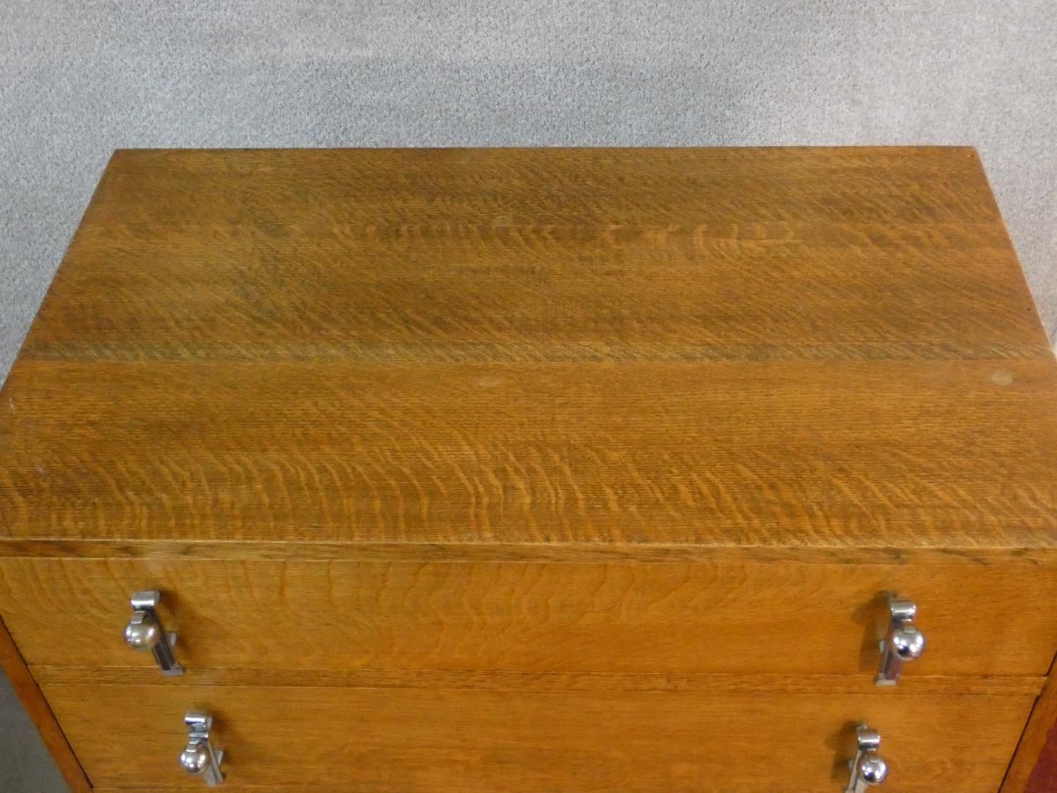 A mid century oak Art Deco style tallboy cabinet with two drawers above panel doors fitted with - Image 3 of 7