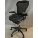 A contemporary Herman Miller ergonomic design tilting and swivelling Aeron office desk chair, size